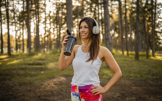 Woman With Headphones and Protein Shake