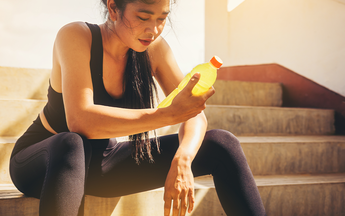 Woman drinking electrolyte powder for recovery