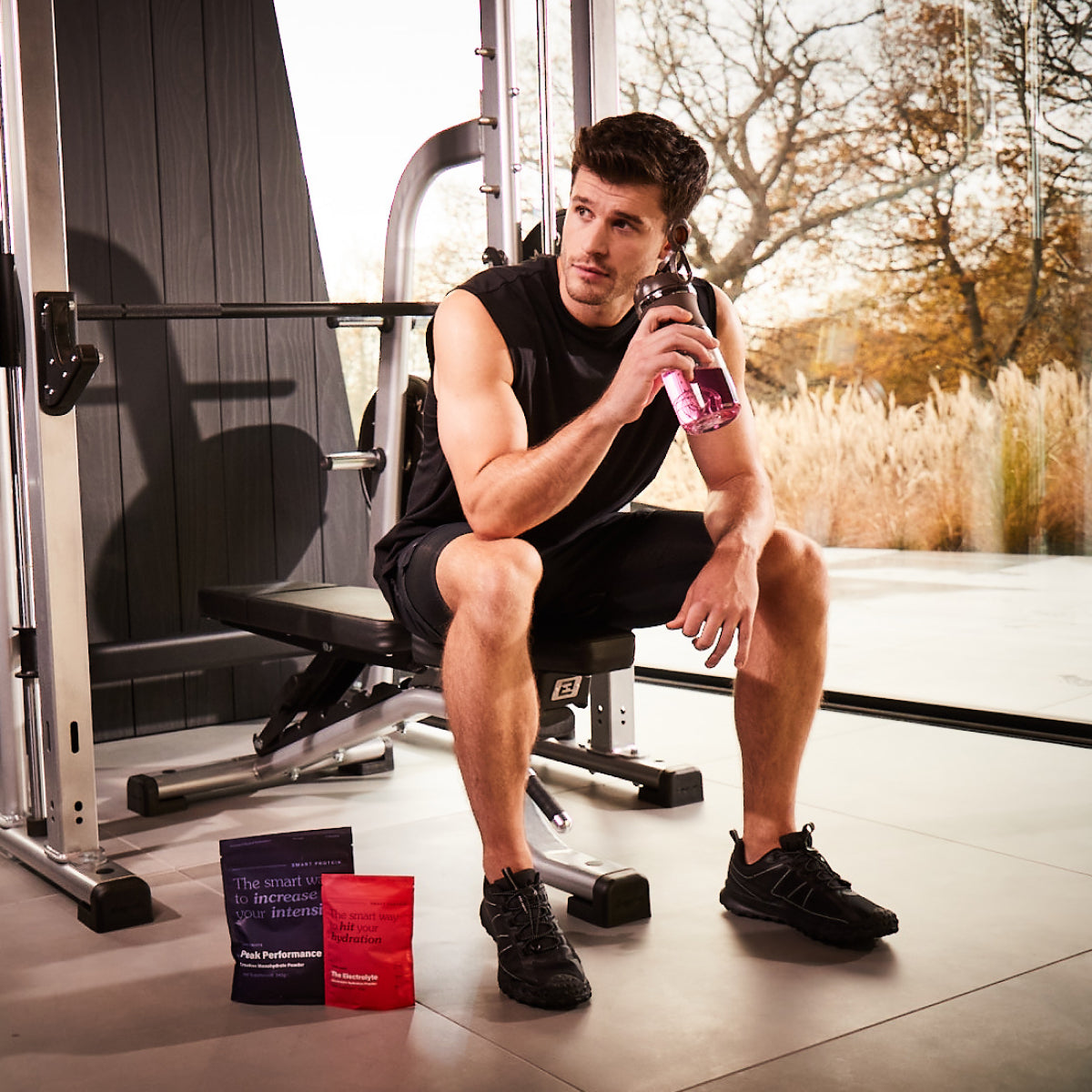 Electrolyte Hydration Powder Next To Man On Gym Bench