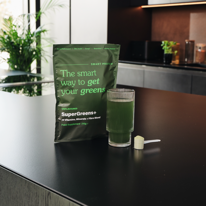 SuperGreens Food Supplement Bag and Glass on Counter Top