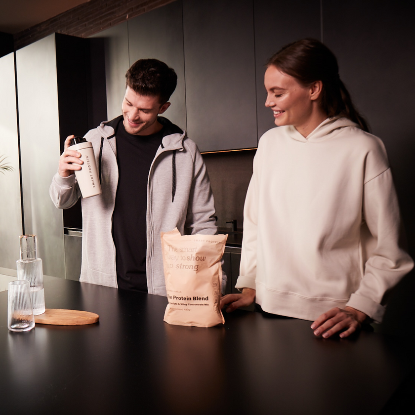 A couple in the kitchen preparing a Whey Isolate Protein Shake